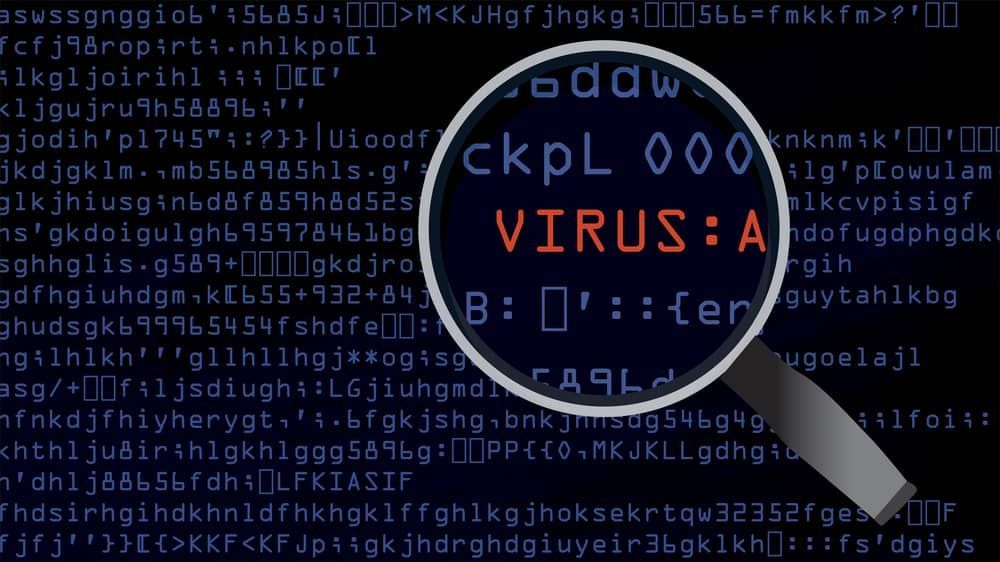 a Magnifying Glass Shows the Word Virus on a Computer Screen — Adaptive PC Solutions In Manoora, QLD