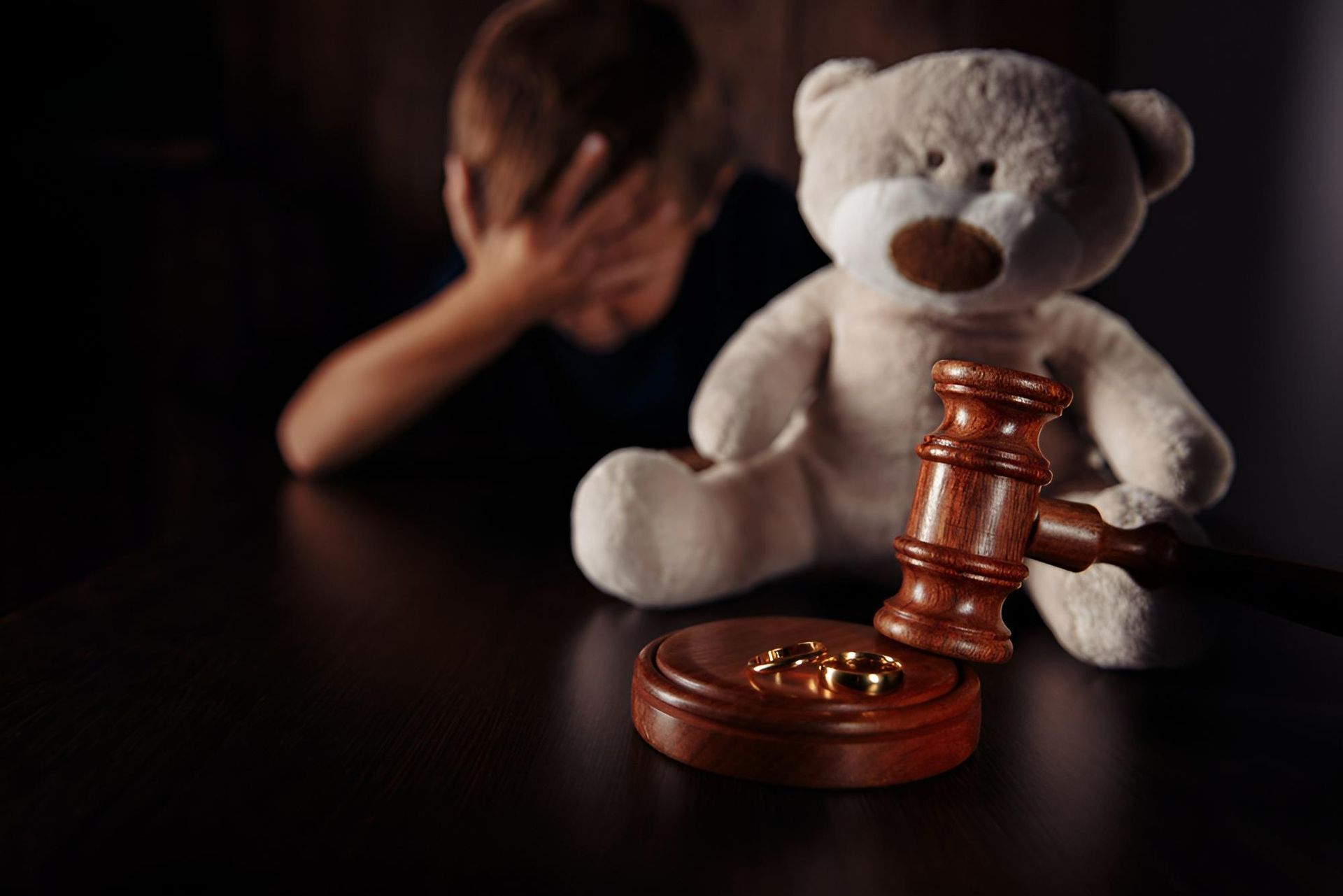 A Teddy Bear is Sitting on a Table Next to a Judge's Gavel — Warland Solicitors in Cessnock, NSW