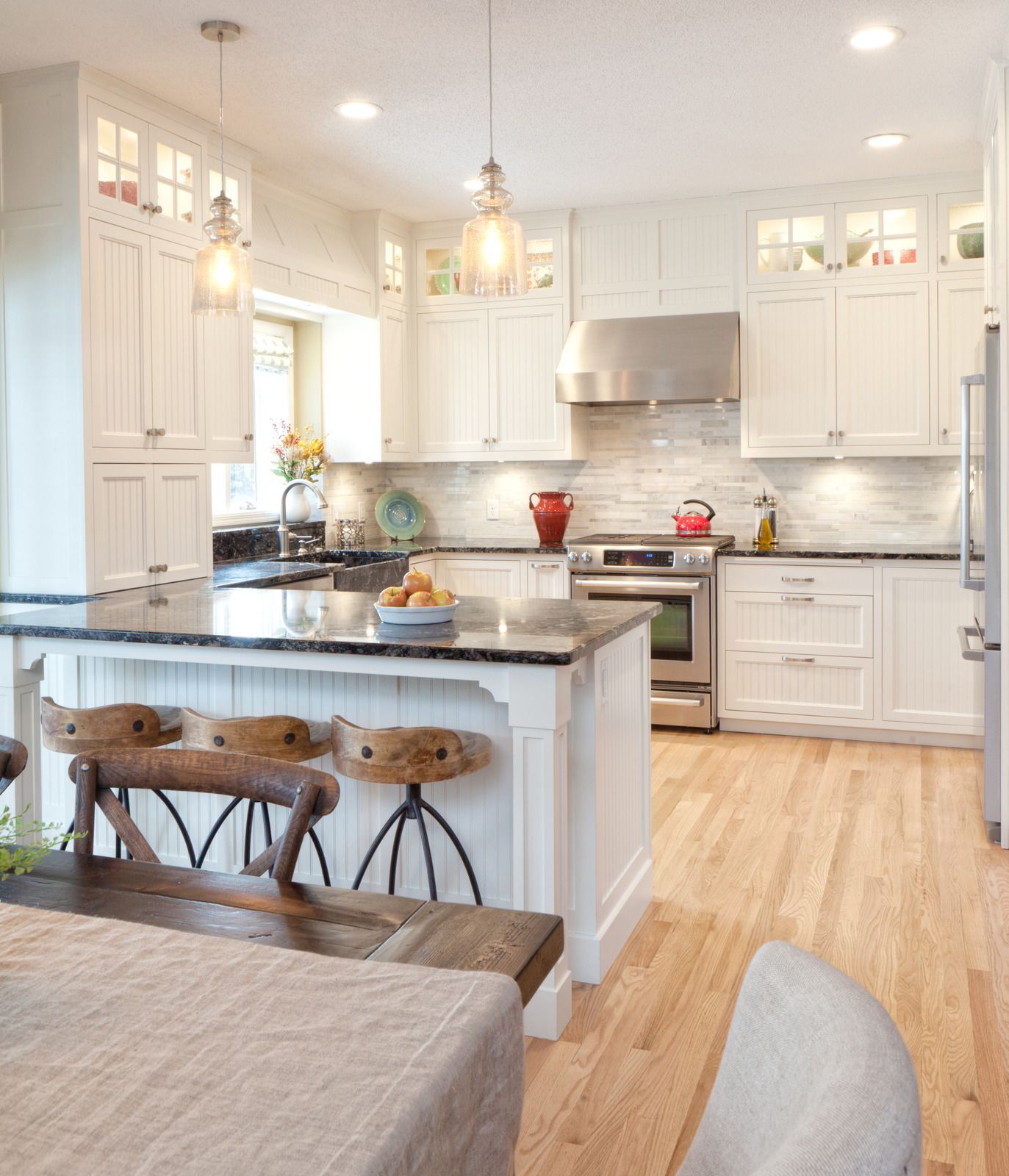 A kitchen with white cabinets and stainless steel appliances