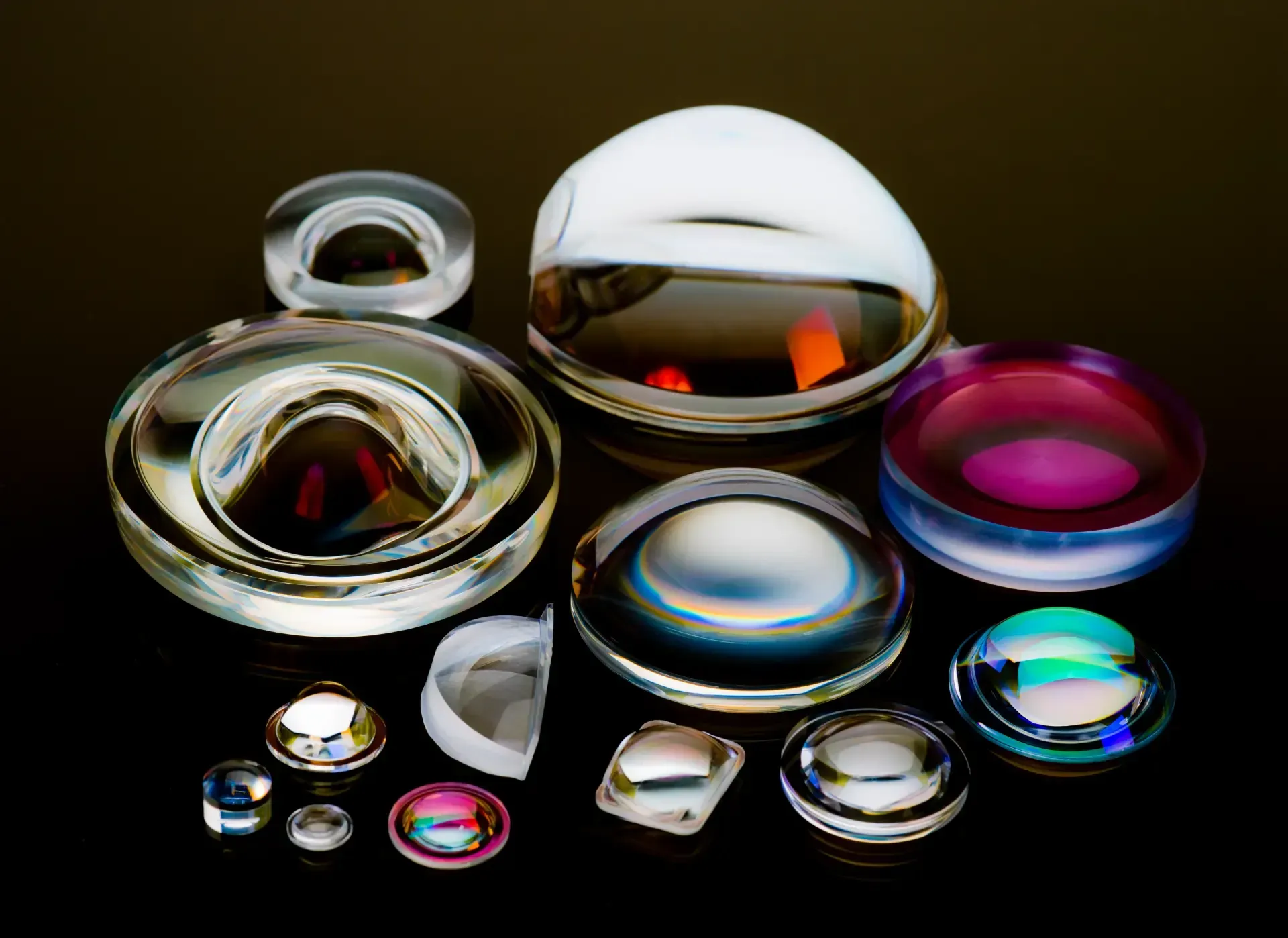 A bunch of different types of glass lenses on a table