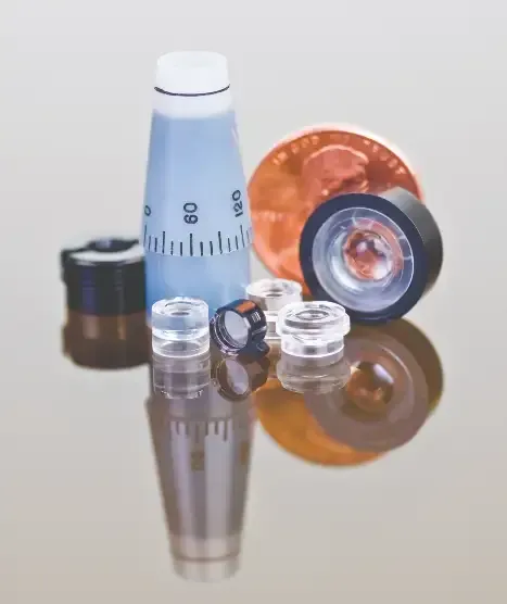 Optical Lenses Sitting on Reflective Table Smaller than Penny