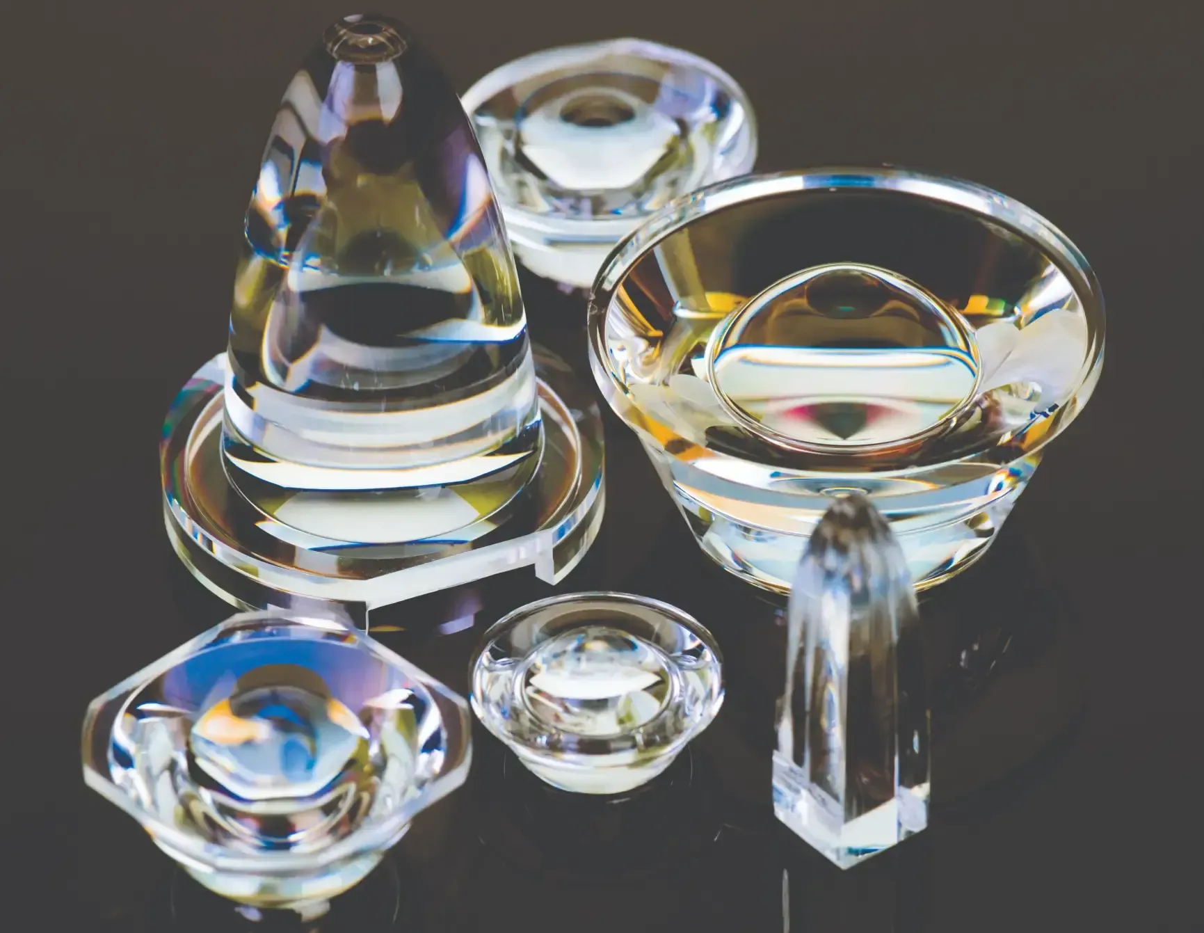 A group of clear glass objects are sitting on a table.