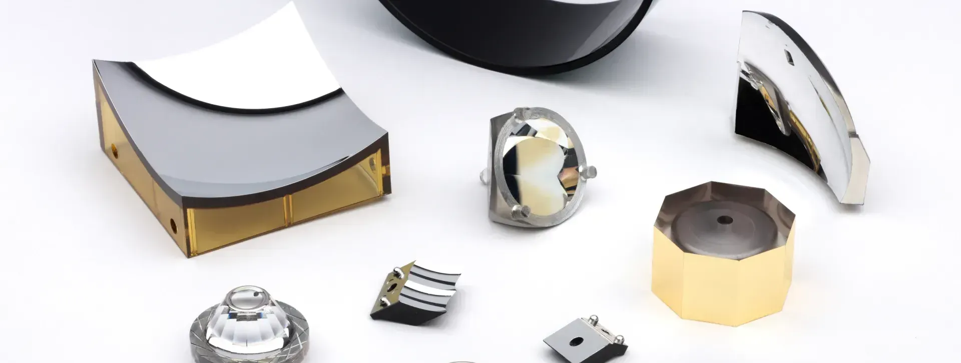 A bunch of metal parts are laying on a white surface