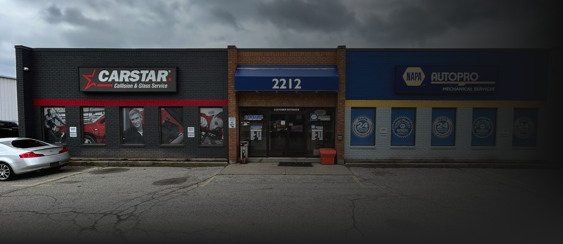 Buildings, left is Carstar, center door is 2212, right is Huckleberry's, all under a cloudy sky | CARSTAR Oakville West