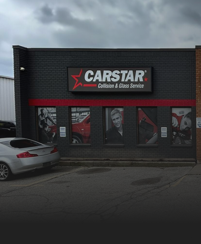 Carstar collision repair shop with a car parked outside. Building has red and black accents | CARSTAR Oakville West