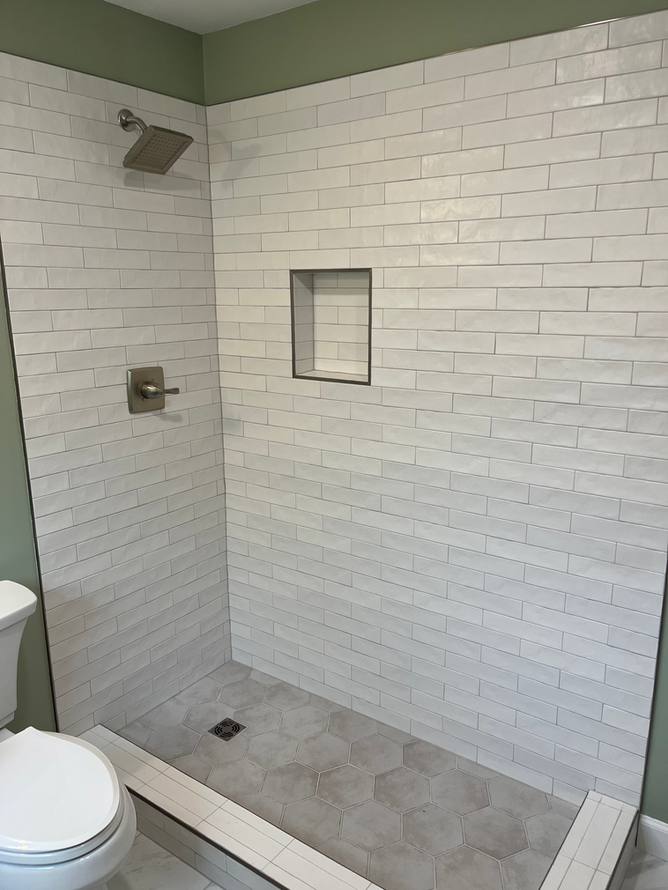 A bathroom with a walk in shower and a toilet.