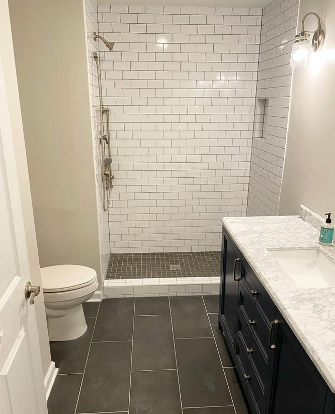 A bathroom with a toilet , sink , and shower.