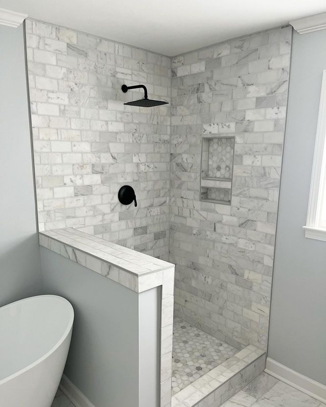 A bathroom with a walk in shower and a bathtub.