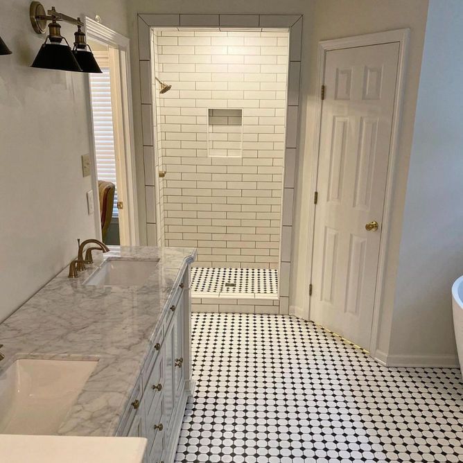 A bathroom with a sink , toilet and shower.