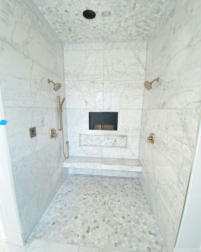 A bathroom with two showers and a fireplace in the shower.