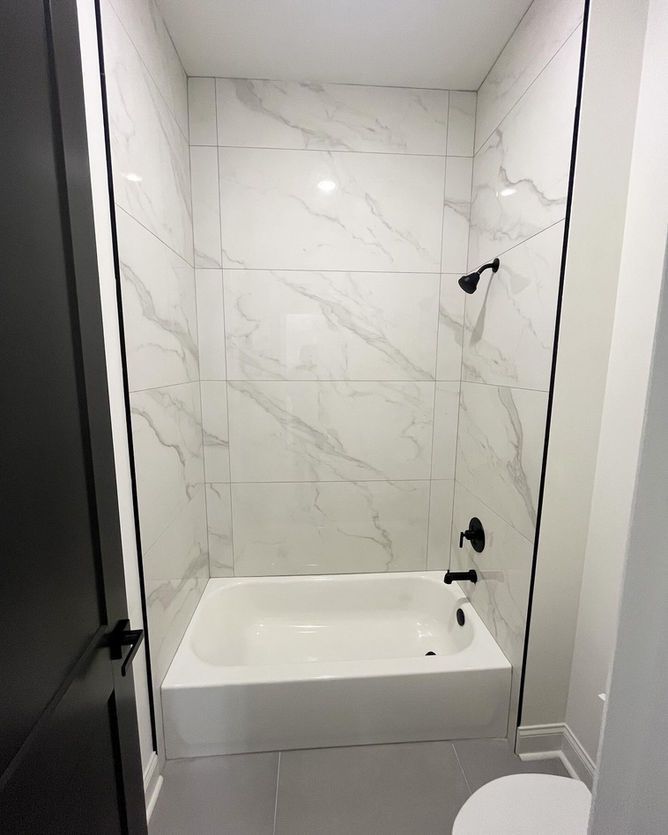 A bathroom with a bathtub and a toilet.