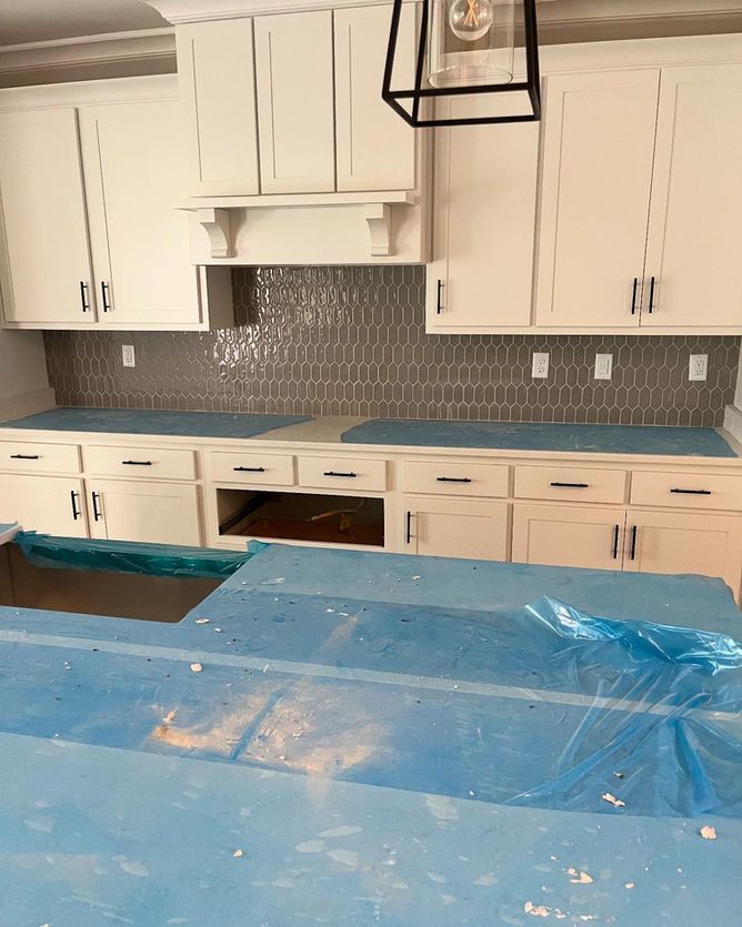 A kitchen with white cabinets and a blue counter top