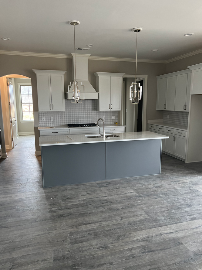 There is a large island in the middle of the kitchen.