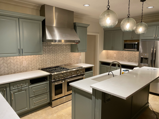 A kitchen with stainless steel appliances and a large island.
