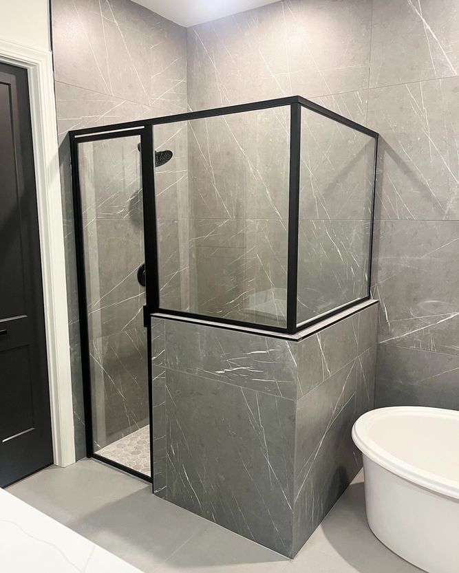 A bathroom with a walk in shower and a bathtub.