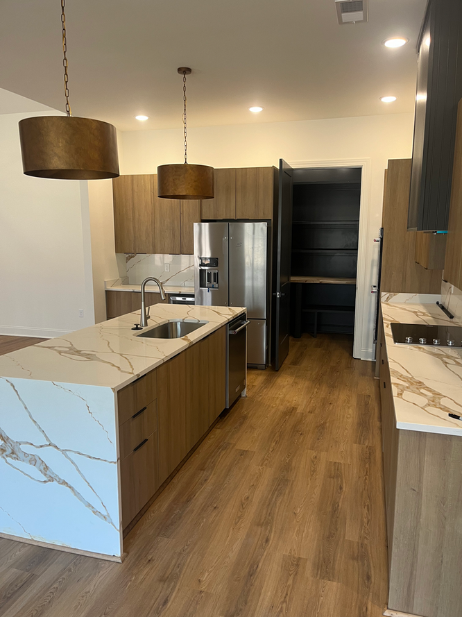 A kitchen with stainless steel appliances and wooden cabinets
