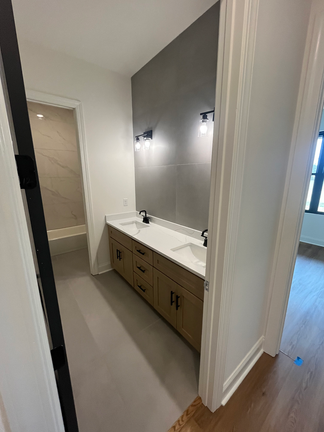 A bathroom with two sinks and a large mirror.