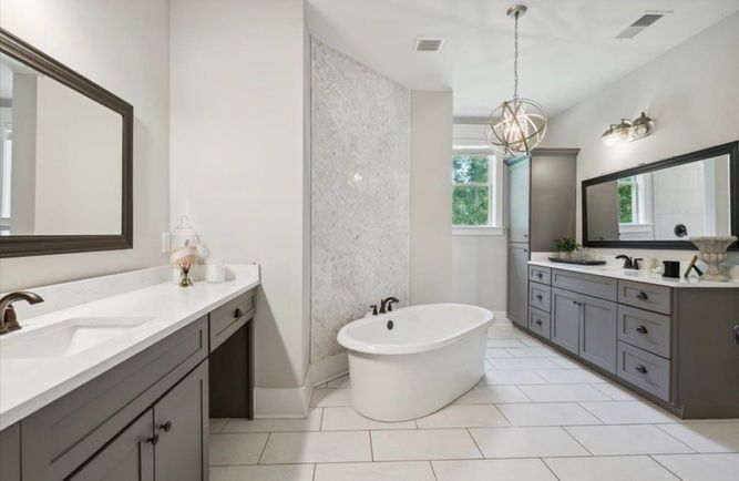 A bathroom with two sinks and a bathtub.