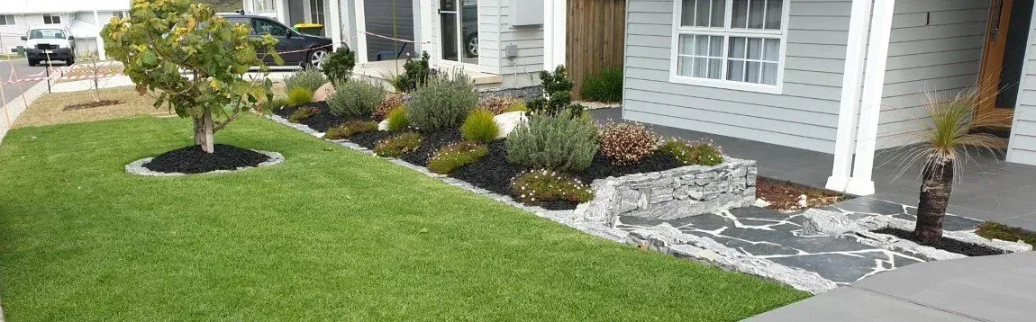 Lush Green Lawn With a Small Tree and Landscaped Garden Bed — Total Perfection In Catherine Hill Bay, NSW