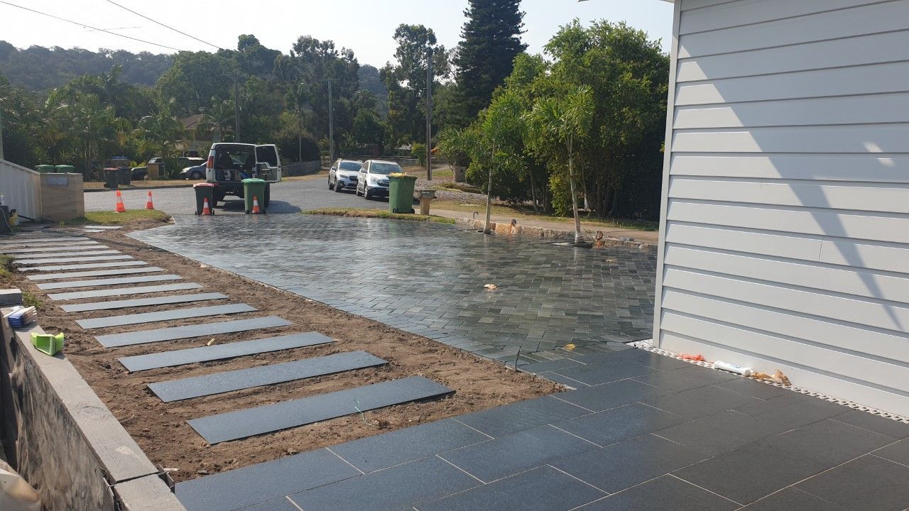 A Newly Landscaped Driveway With a Stone Walkway — Total Perfection In Kariong, NSW