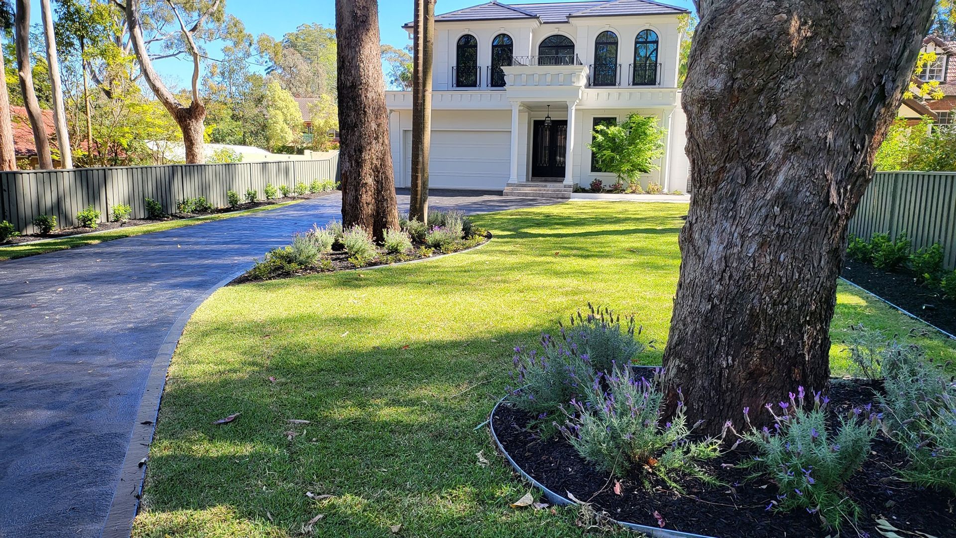White Two-story House With Arched Windows and a Paved Driveway — Total Perfection In Gosford, NSW