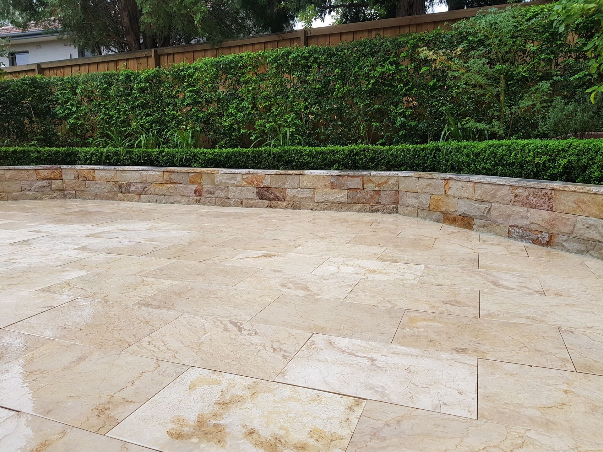 Stone Patio With a Low Stone Wall — Total Perfection In Bateau Bay, NSW