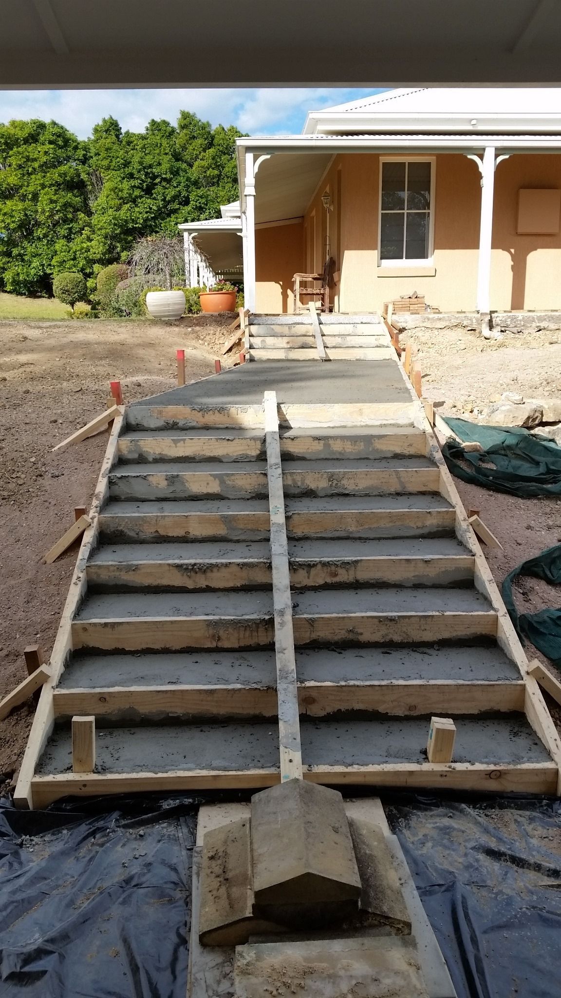 Concrete Steps Under Construction Leading Up to a House With a Veranda — Total Perfection In Kariong, NSW