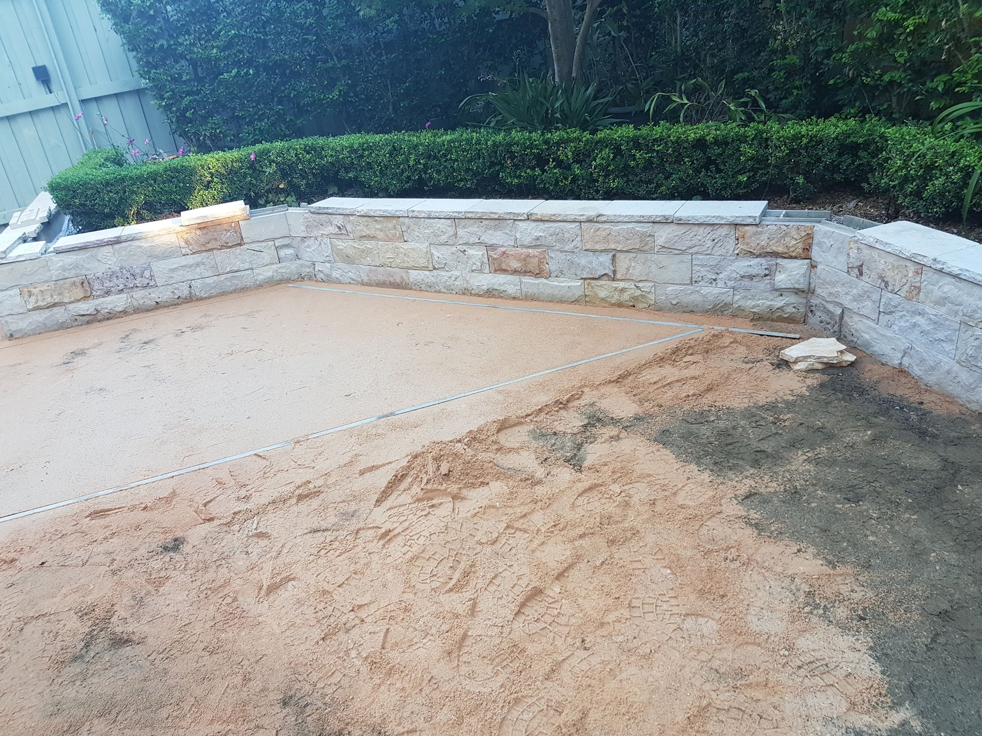 Stone Retaining Wall Encloses Sandy Ground — Total Perfection In Kariong, NSW