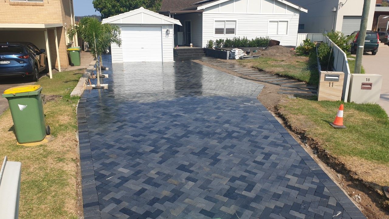Newly Paved Driveway in Front of a White House With a Garage — Total Perfection In Kariong, NSW
