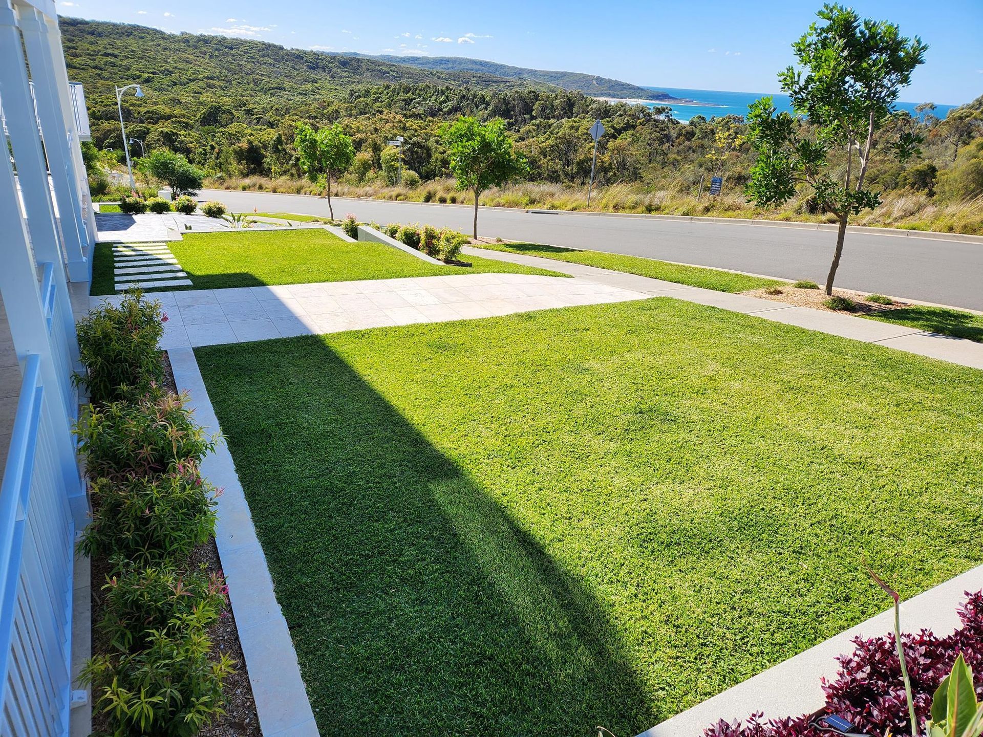 Green Lawns and Bushes Along a White Building and Road — Total Perfection In Bateau Bay, NSW