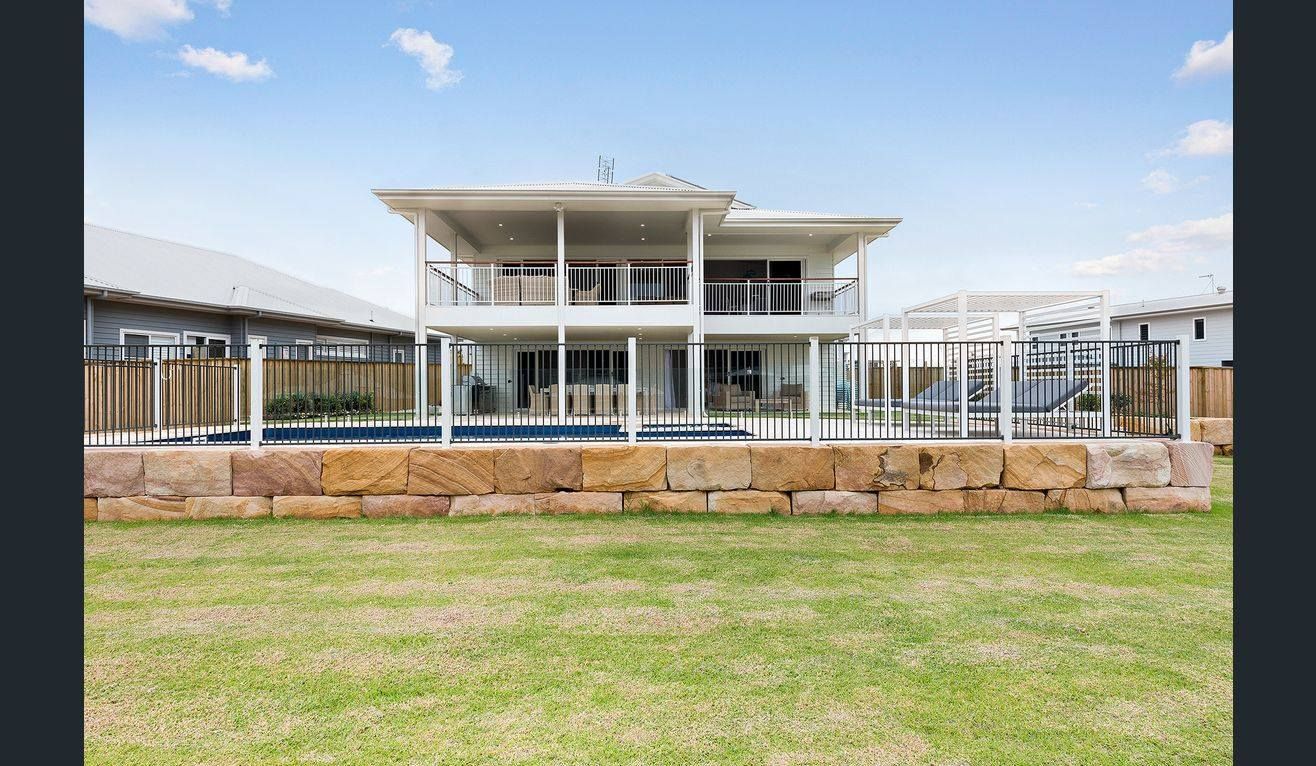 Two-Storey White House With Balconies and Stone Wall — Total Perfection In Erina, NSW