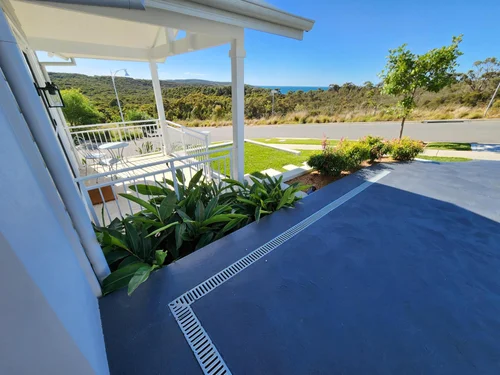Exterior of a White House With a Covered Porch, Lush Greenery — Total Perfection In Catherine Hill Bay, NSW