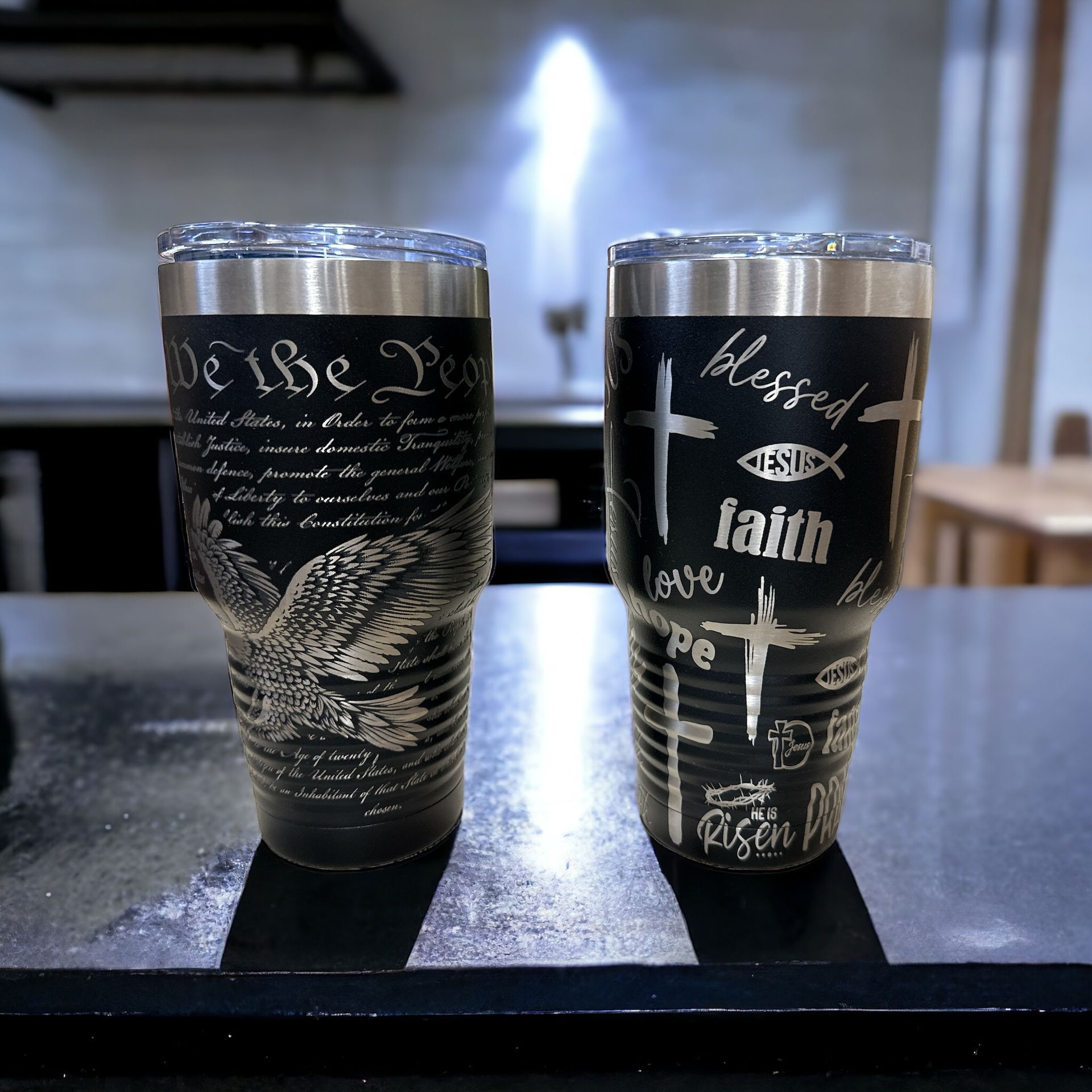 two tumblers on a counter with one that says we the people