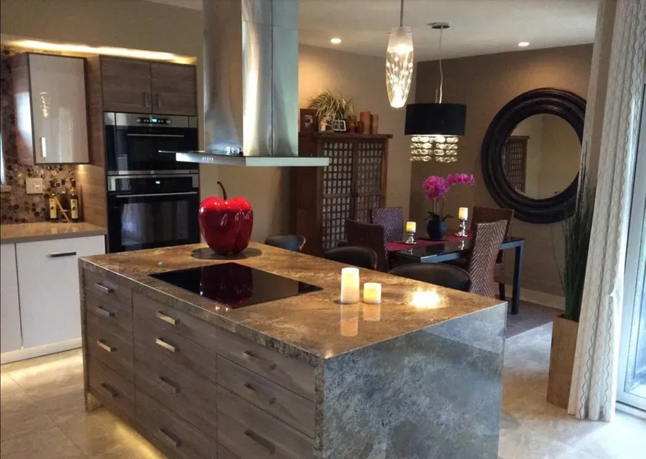 A kitchen with a large island and a stove top oven