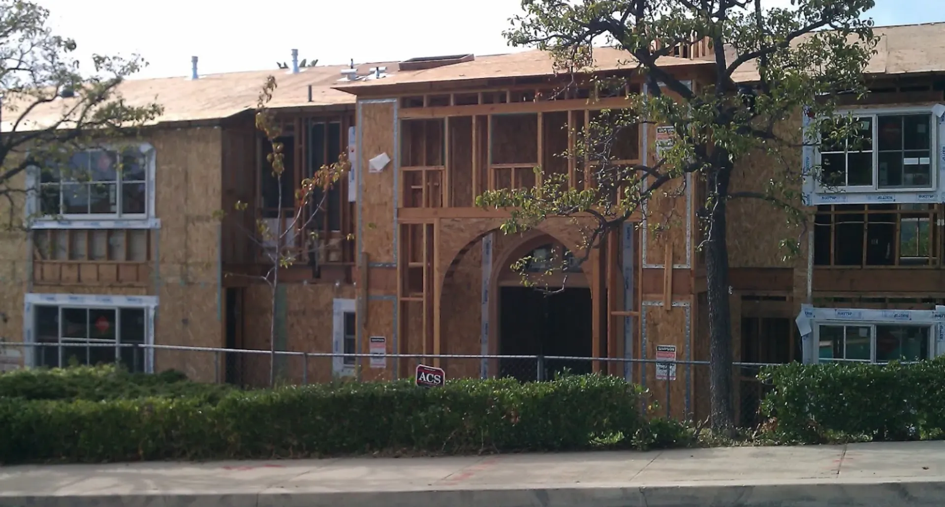 A large building under construction with a fence around it