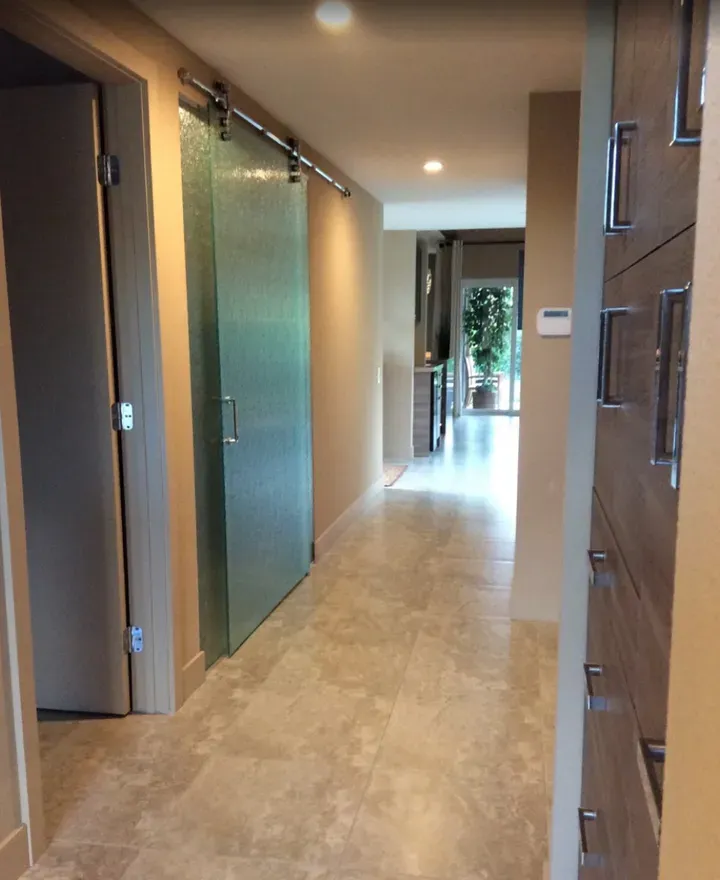 A long hallway with a sliding glass door