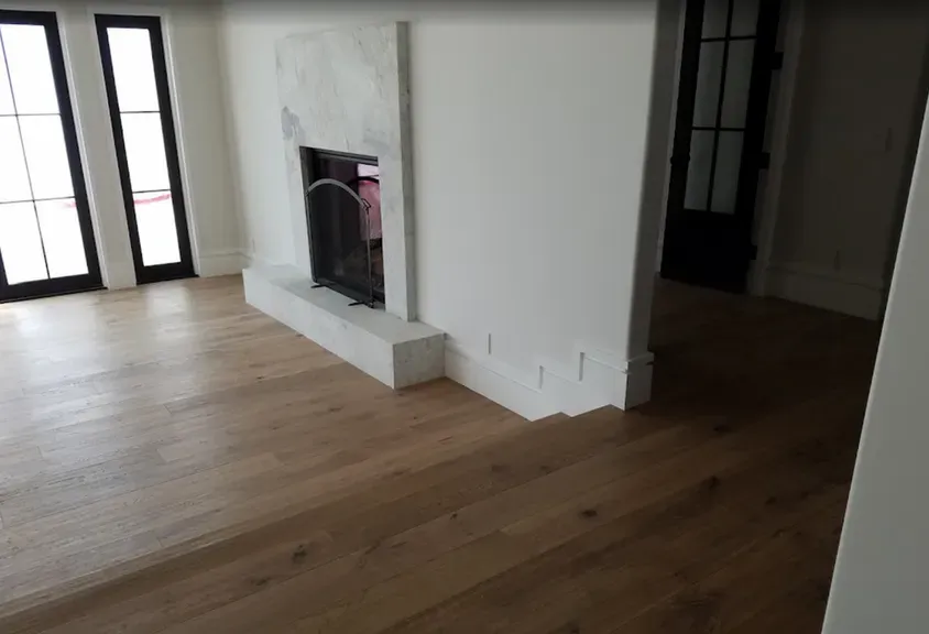 A living room with hardwood floors and a fireplace