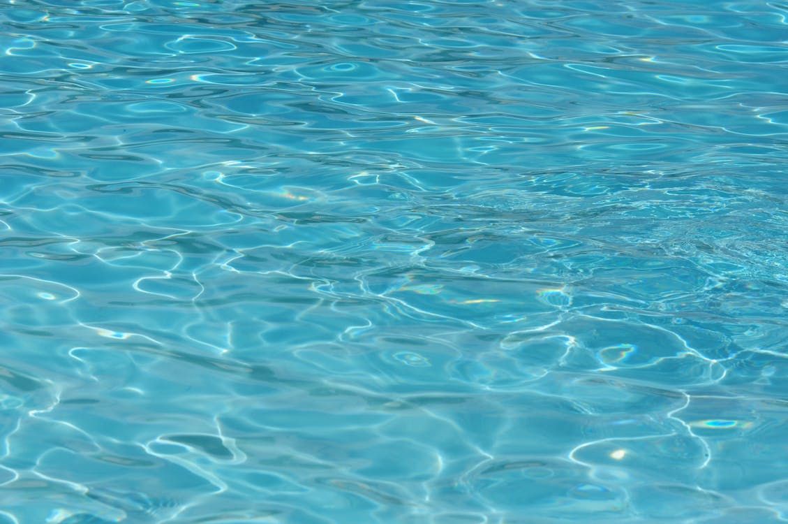 A close up of a swimming pool with blue water.