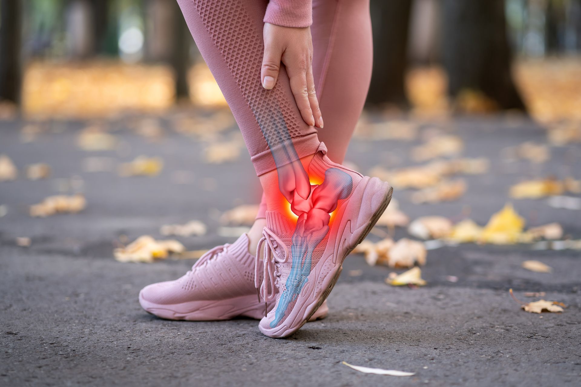 A woman is holding her ankle in pain.