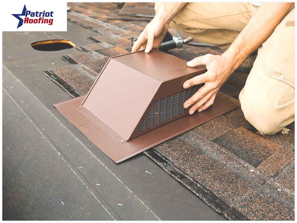 A man is installing a vent on a roof.