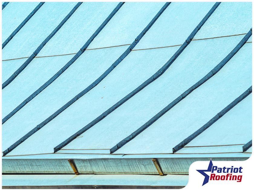 A blue roof with a patriot roofing logo in the corner