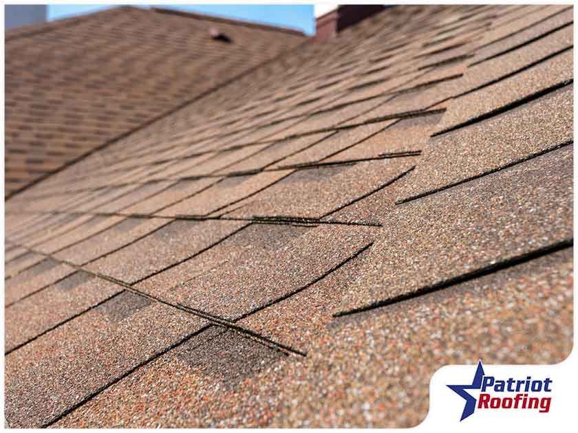 A close up of a roof with patriot roofing written on the bottom