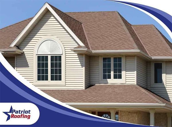 A patriotic roofing ad for a house with a brown roof