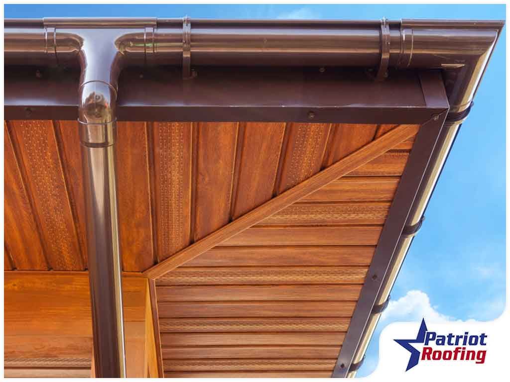 A close up of a wooden roof with a gutter.