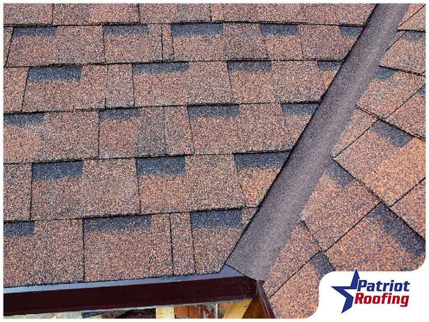 A close up of a roof with patriot roofing written on the bottom