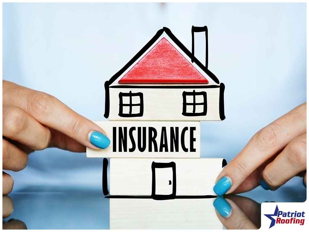 A person is holding a stack of books with a house drawn on them.