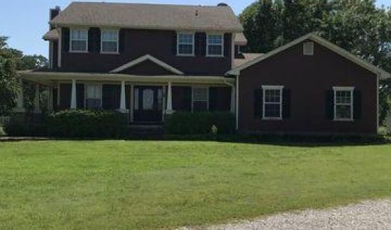 A large house with a large lawn in front of it