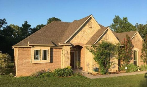 A large brick house with a brown roof