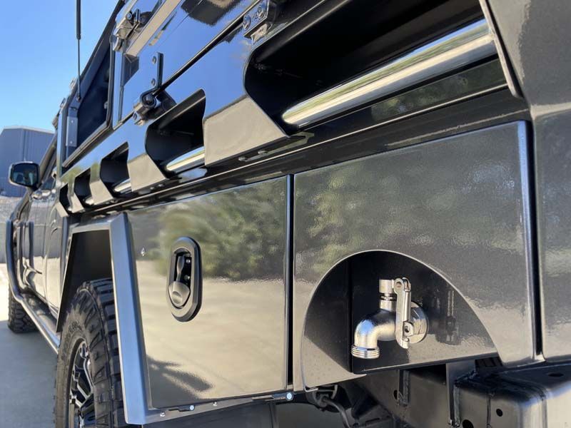A black truck with a faucet on the side of it.