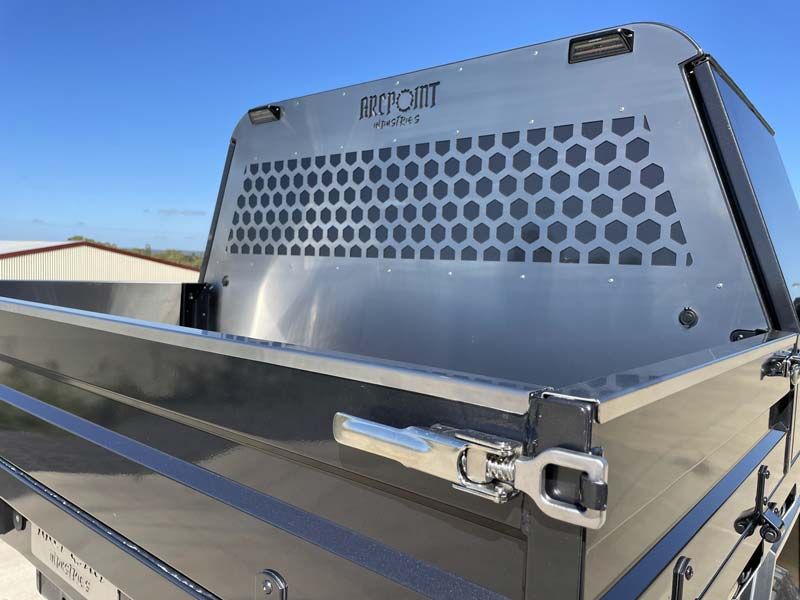 The back of a truck with a stainless steel bed and a canopy.
